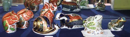 A collection of seven Crown Derby animal paperweights: three squirrels, a snail, a badger and two toad s